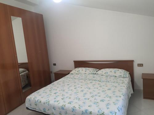a bedroom with a bed and a mirror at Artemide Residence Acquaviva in Acquaviva dʼIsernia