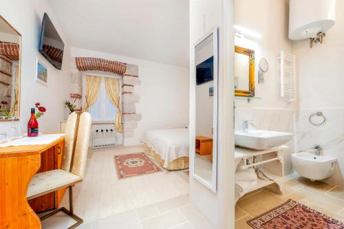 a bathroom with a sink and a mirror at The Palace RoomS in Rovinj