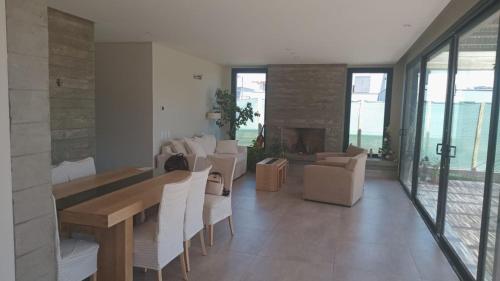 a living room with a table and chairs and a fireplace at Leonel caceres Vacacional in Neuquén