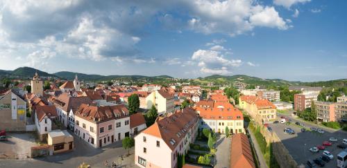 an aerial view of a town with buildings and cars at Hotel Grand Litava Beroun in Beroun