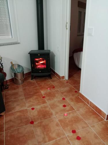 a room with a fireplace with red hearts on the floor at Casa turística Lirio in Chandreja