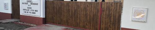 a wooden fence with a sign on it at Gavriel Boutique Residence Wellness Spa in Szada