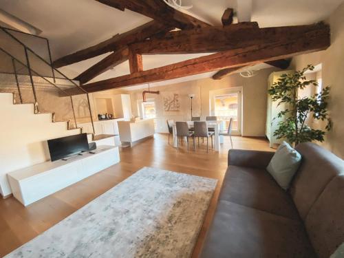 a living room with a couch and a tv at Ponte Pietra Luxury Home in Verona in Verona