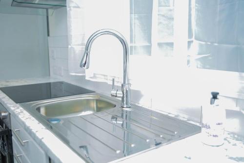 a stainless steel sink in a white kitchen at Brookland Avenue in Sunderland