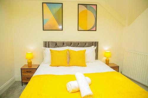 a bedroom with a yellow bed with two lamps at Brookland Avenue in Sunderland