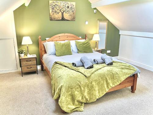a bedroom with a large bed with green walls at Modern 4-bed stay-away-home sleeps 8 in Preston in Preston