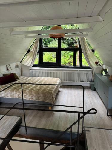 a bedroom with two beds and a window at Historische Breidenmühle in Haan