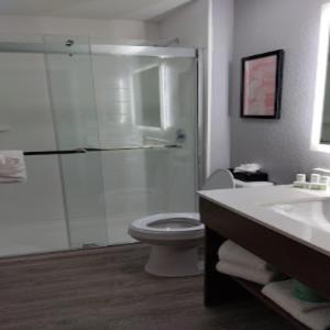 a bathroom with a shower and a toilet and a sink at Hawthorn Extended Stay by Wyndham Bedford - Dallas in Bedford