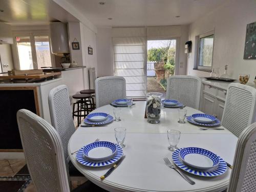 a table with blue and white plates on it in a kitchen at Albizia in Saint-Pair-sur-Mer