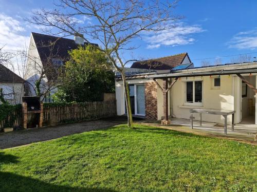 a house with a tree in the yard at Albizia in Saint-Pair-sur-Mer