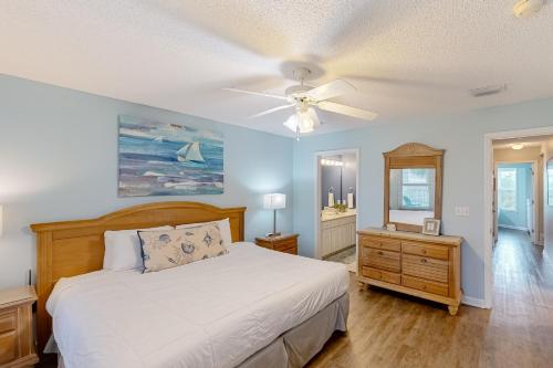a bedroom with a bed and a ceiling fan at White Sands Retreat in Port Saint Joe