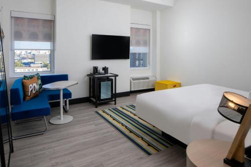 a hotel room with a bed and a tv at Aloft Memphis Downtown in Memphis