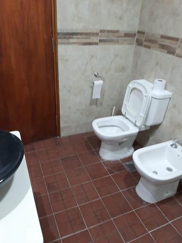 a bathroom with a toilet and a sink at Casa la 12 in Miramar