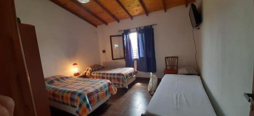 a hotel room with two beds and a window at Casa la 12 in Miramar
