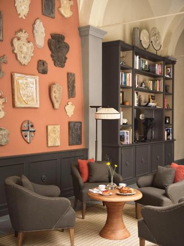 a living room with two chairs and a table at Collegio alla Querce, Auberge Collection in Florence