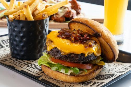 a cheeseburger on a plate with french fries at Delta Hotels by Marriott West Palm Beach in West Palm Beach