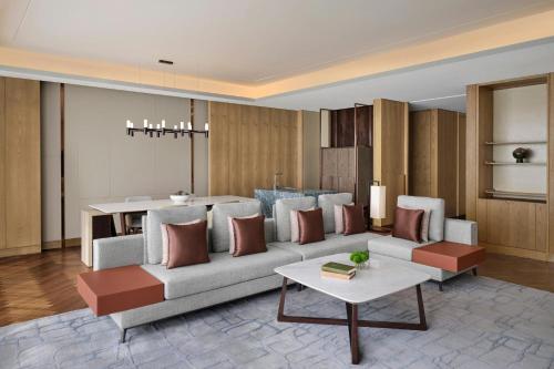 a living room with a couch and a table at JW Marriott Hotel Taiyuan in Taiyuan