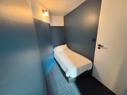 a small bedroom with a bed in a blue room at Sure Hotel by Best Western Annecy in Annecy