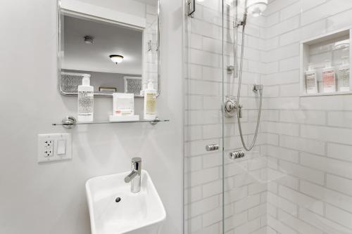 a white bathroom with a sink and a shower at Nantucket Resort Collection in Nantucket
