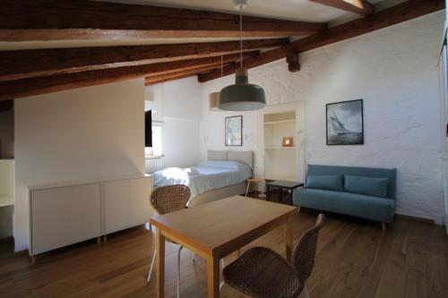 a bedroom with a bed and a table and a couch at Alle scalette in Trieste