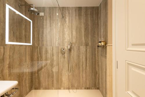 a shower with a glass door in a bathroom at Palazzo Doni by Florence Art Apartments in Florence