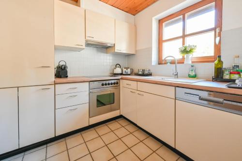 a kitchen with white cabinets and a sink at Galeriewohnung in Menzenschwand in Menzenschwand-Hinterdorf