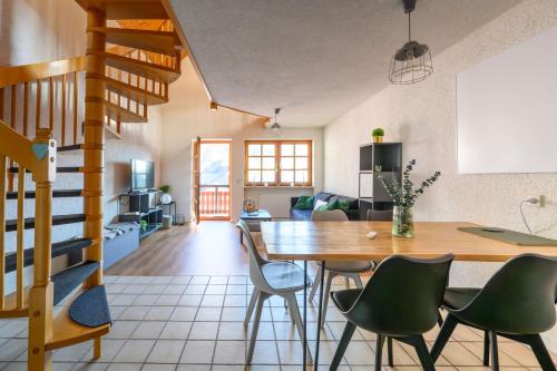 a dining room and living room with a table and chairs at Galeriewohnung in Menzenschwand in Menzenschwand-Hinterdorf