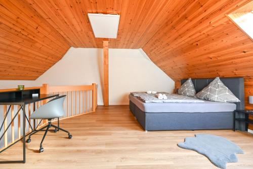 a bedroom with a bed and a desk in a room at Galeriewohnung in Menzenschwand in Menzenschwand-Hinterdorf