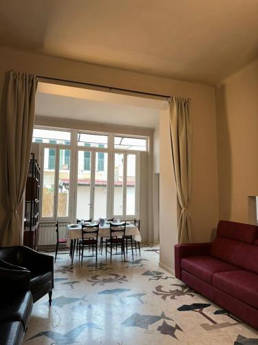 a living room with a red couch and a table at casa greta in Viareggio