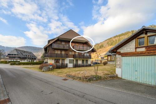 a house with a hoop on the side of a road at Galeriewohnung in Menzenschwand in Menzenschwand-Hinterdorf