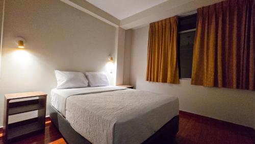 a hotel room with a bed and a window at Huara Hs in Tacna