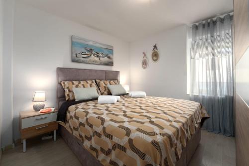 En eller flere senge i et værelse på La Vista Apartment