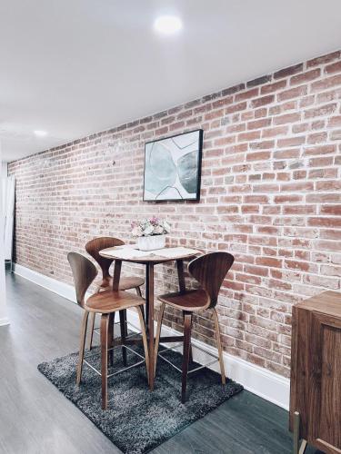 a table and chairs in front of a brick wall at North Capitol Charm in Washington, D.C.