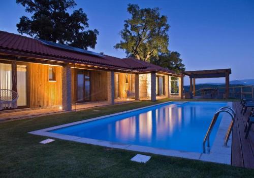 a swimming pool in the yard of a house at Casa do Sobreiro / Casas de Basto in Celorico de Basto