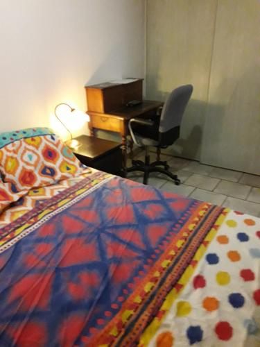 a bedroom with a desk and a bed and a desk and chair at Chambre 4 in Bouc-Bel-Air