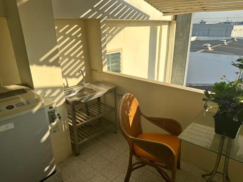 a small kitchen with a sink and a window at Aomsin Premium Hotel Suit Near Shoping Malls in Ban Lam Rua Taek