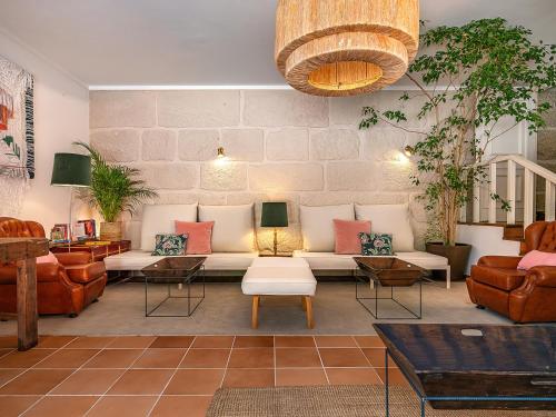 a living room with a couch and chairs at TAMACA nature in Marco de Canaveses