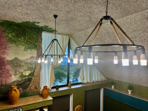 two chandeliers hanging from a ceiling with a window at Qafqaz Retro Bungalow HOT POOL in Gabala