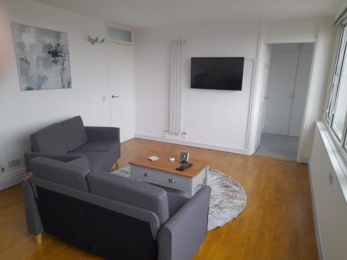 a living room with a couch and a table at Magnolia Penthouse in Windsor