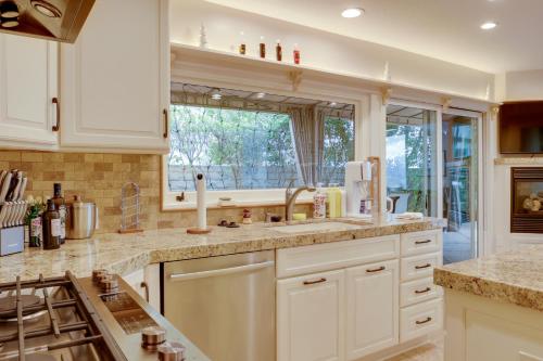 a kitchen with white cabinets and a large window at 2 Mi to Promenade at Westlake Mtn-View Haven! in Westlake Village