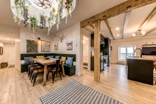 a dining room and living room with a table and chairs at North House - Spectacular 3 Bedroom Old Quebec Penthouse in Quebec City