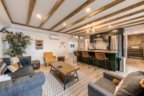 a living room with two couches and a kitchen at North House - Spectacular 3 Bedroom Old Quebec Penthouse in Quebec City