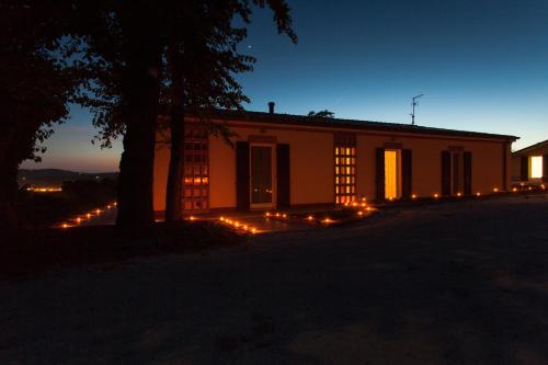 a house with lights in front of it at night at Venticello Del Conero in Gli Angeli