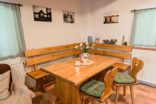 a dining room with a wooden table and chairs at Apartmány Na Špejcharu in Stříbřec