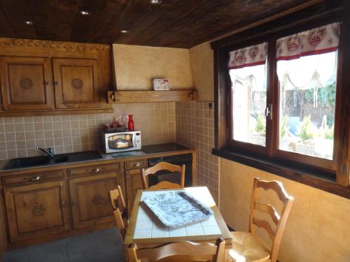 een keuken met een tafel en een tafel en stoelen bij Chalet Chez Gaby in Morzine