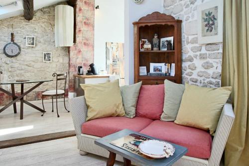 un salon avec un canapé rouge et une table dans l'établissement Studio St Rémy Historic Center/Air-com, à Saint-Rémy-de-Provence