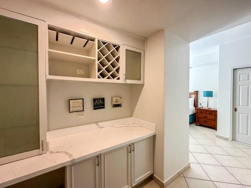 a kitchen with white cabinets and a counter top at 3BR Condo at Iconic Sandy Beach Area in Puerto Peñasco