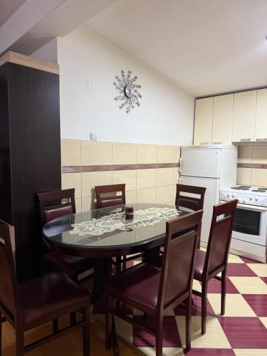 a kitchen with a dining room table and chairs at Kalinka Apartment in Bitola