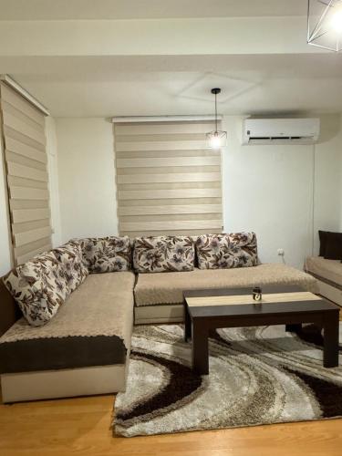 a living room with a couch and a coffee table at Kalinka Apartment in Bitola