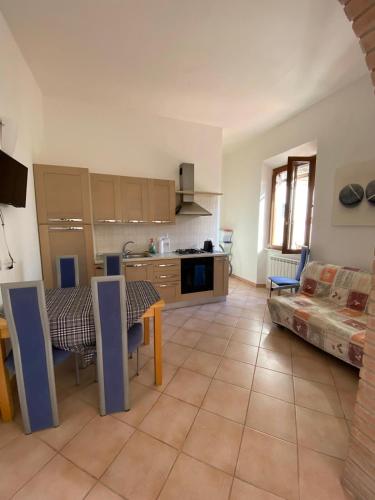 a large kitchen with a table and a kitchen with a tableablish at Villa La Pila Bilo in Marina di Campo